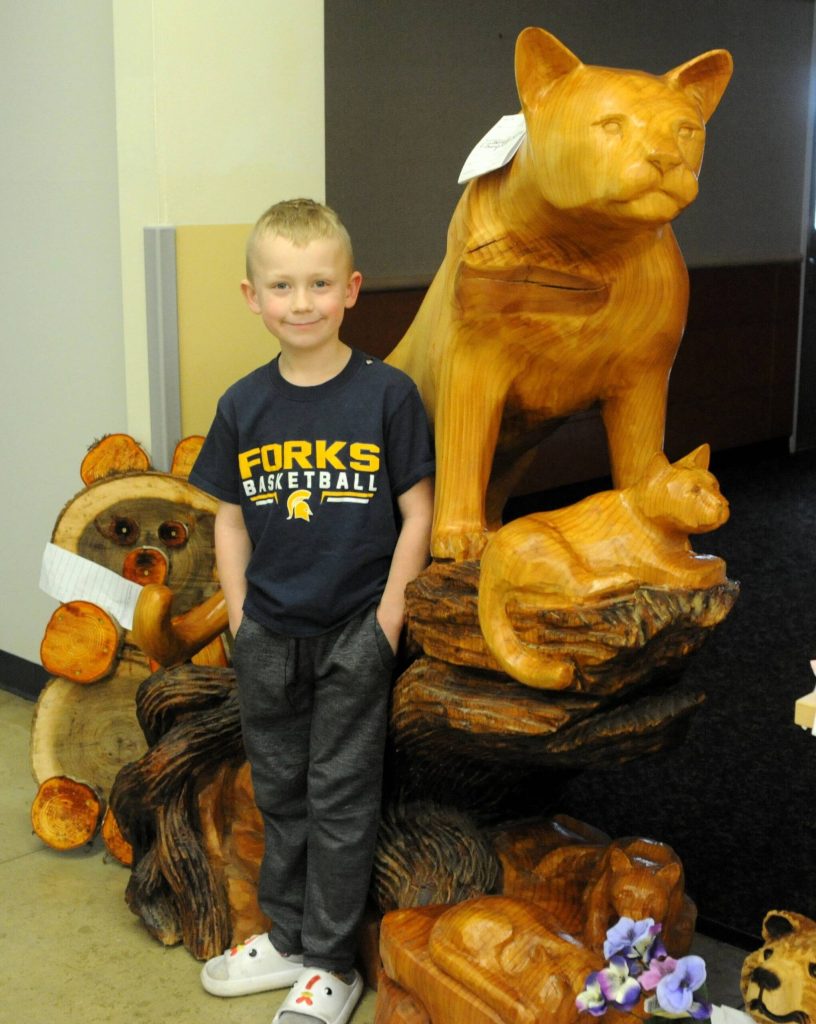 Photo by Lonnie Archibald
The cougar wood carving didnt bother young Charlie Echeita any. The carving saw some lively bidding on Sunday afternoon.