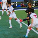 Left, Washington State wrestling champ Abraham Montealegre also competes in soccer, as is seen here where he kicks between Grizzlies Alan Torres and Michael Garcia Thursday, April 3 at Spartan Stadium.