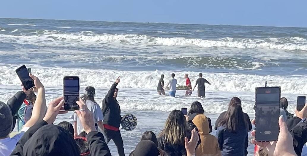 After the dances and songs were performed four students carried the salmon offering into the surf.