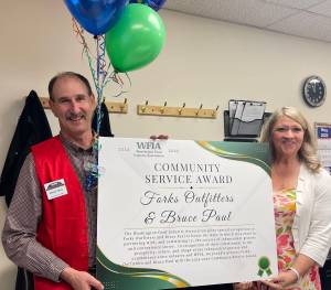 Photo Christi Baron 
WFIA President CEO Tammie Hetrick presents Bruce Paul, owner of Forks Outfitters and Ace Hardware, with the WFIA 2024-25 Community Service Award. The award was presented at a surprise ceremony held May 7 at the store in Forks.