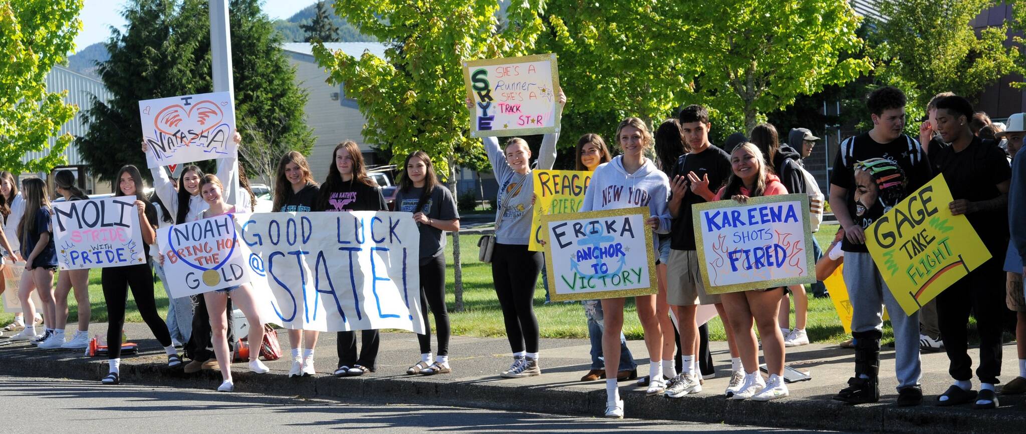 Signs support the Spartan track and field team as students wait in front of the Forks High School for the bus en route to Yakima last week. Photo by Lonnie Archibald