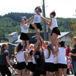 Photo Lonnie Archibald
Coastal Cheer members create an enthusiastic stunt, during the Grand Parade on Friday.