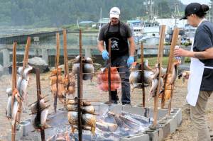 Photos by Lonnie Archibald
With the LaPush Marina in the background, Matt Payne and Smokey Ward keep close eyes on the salmon during the traditional salmon bake on Saturday during Quileute Days in LaPush. More photos page 3.