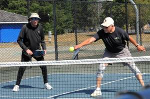 Photo by Lonnie Archibald
One of the fastest growing sports is that of pickleball. While Bert Paul looks on, John Calhoun returns the ball over the net Friday Aug. 1 at Tilicum Park in Forks.