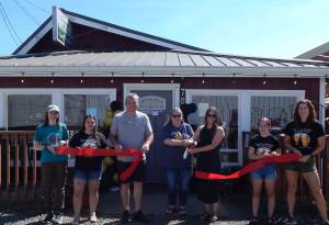 It was a great weekend to celebrate as Westend Taproom Tip and Sip marked one year in business. The Forks Chamber facilitated a Ribbon Cutting ceremony on Saturday afternoon. Business owners Mike and Amy Dilley are left and right of Forks Chamber director Lissy Andros, center, as they cut the ribbon. Tip and Sip staff and Chamber staff helped hold the ribbon. Live music and fun followed through the evening.
Photo Christi Baron