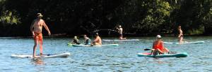 These pleasant Paddleboarders were many on Sunday afternoon at the Lake Pleasant County Park where many took to the lake to escape the heat. Paddleboarding and kayaking are both growing sports. Swimmers, boaters, tubers and picnickers were also out for a pleasant day. A pleasant day that is at Pleasant. Photo by Lonnie Archibald