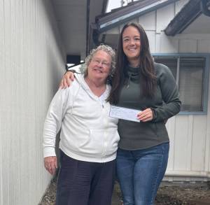 Submitted photo
Susie Bandelius, left, presents Sarah Fletcher with a check.