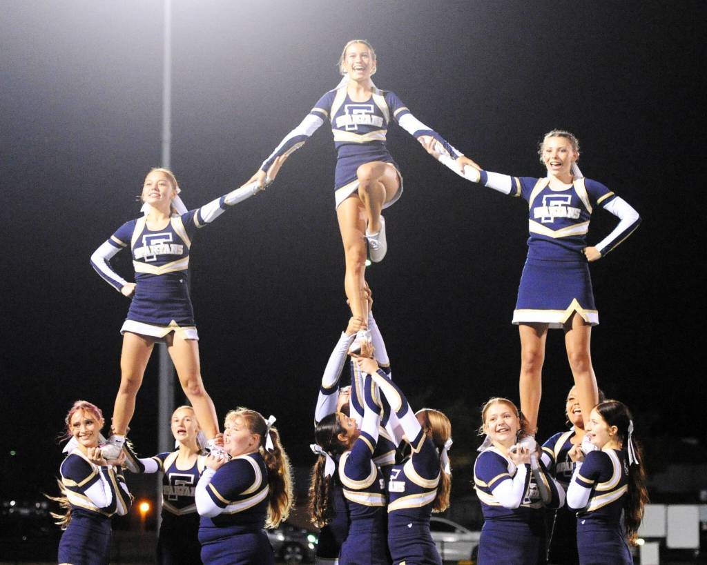 The Spartan cheerleaders in action during halftime of the Forks vs Sequim game at Spartan Stadium.