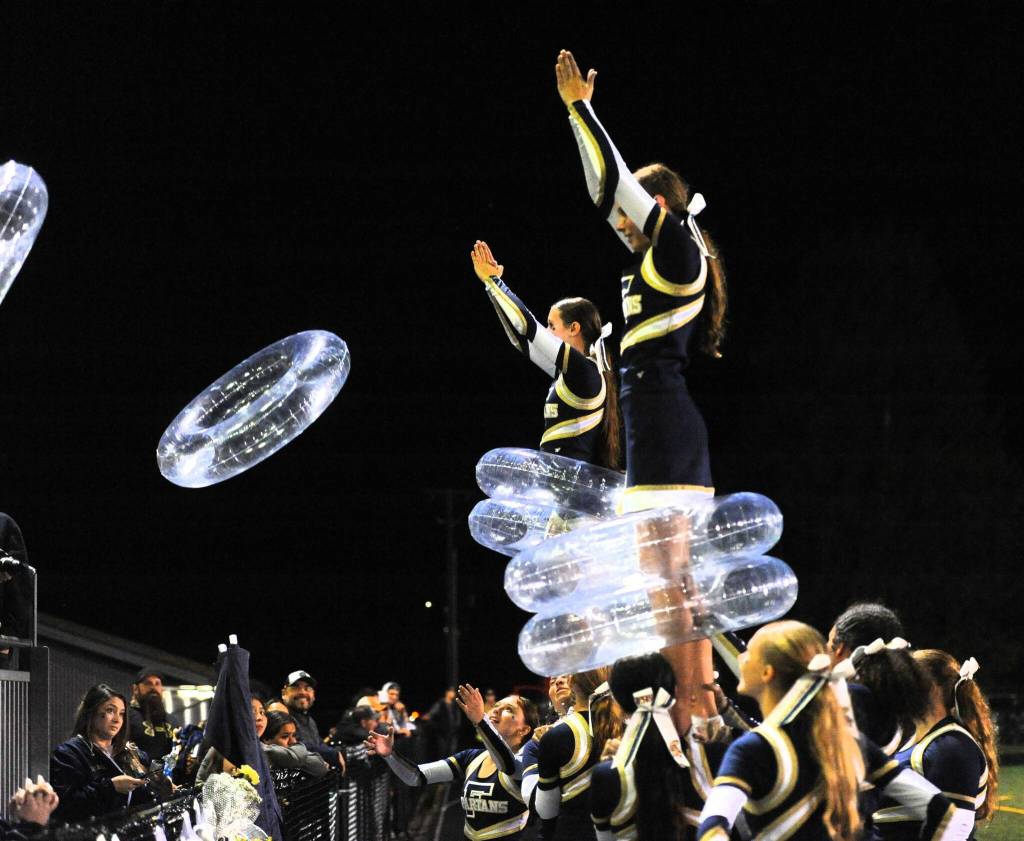 Photo by Lonnie Archibald
The Forks cheerleaders kept quite active during homecoming, as is seen here, where they participated in a ring-toss around the cheerleaders contest.