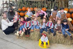 Photo Christi Baron
The setup for the Little Logger photo always takes longer than the contest! A few of the tiniest lumberjacks needed parental backup  one or two looked ready for a nap instead of a log roll and a few were more interested in the hay.