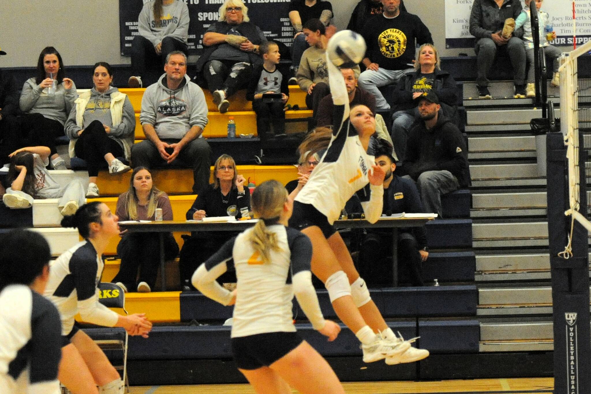 Forks Karee Neel hits against Ocosta while teammates look on.