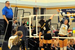 Photos by Lonnie Archibald
Forks Kailyn Crowder (9) in action at the net against North Beach in the Spartan Gym while shirtless Spartan rooters, (bottom left) cheer the girls on to victory.