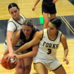 Photo by Lonnie Archibald
Spartans Chloe Gaydeski (12) and Skye Hestand pressure this Montesano Bulldog on December 19 in Forks, where the Bulldogs escaped with a 44 to 40 win.