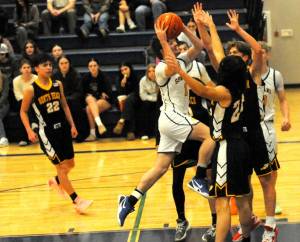 Photos by Lonnie Archibald
Spartan Malachi Rowley drives the key against the North Beach Hyaks in this contest won by Forks by 63 to 50.