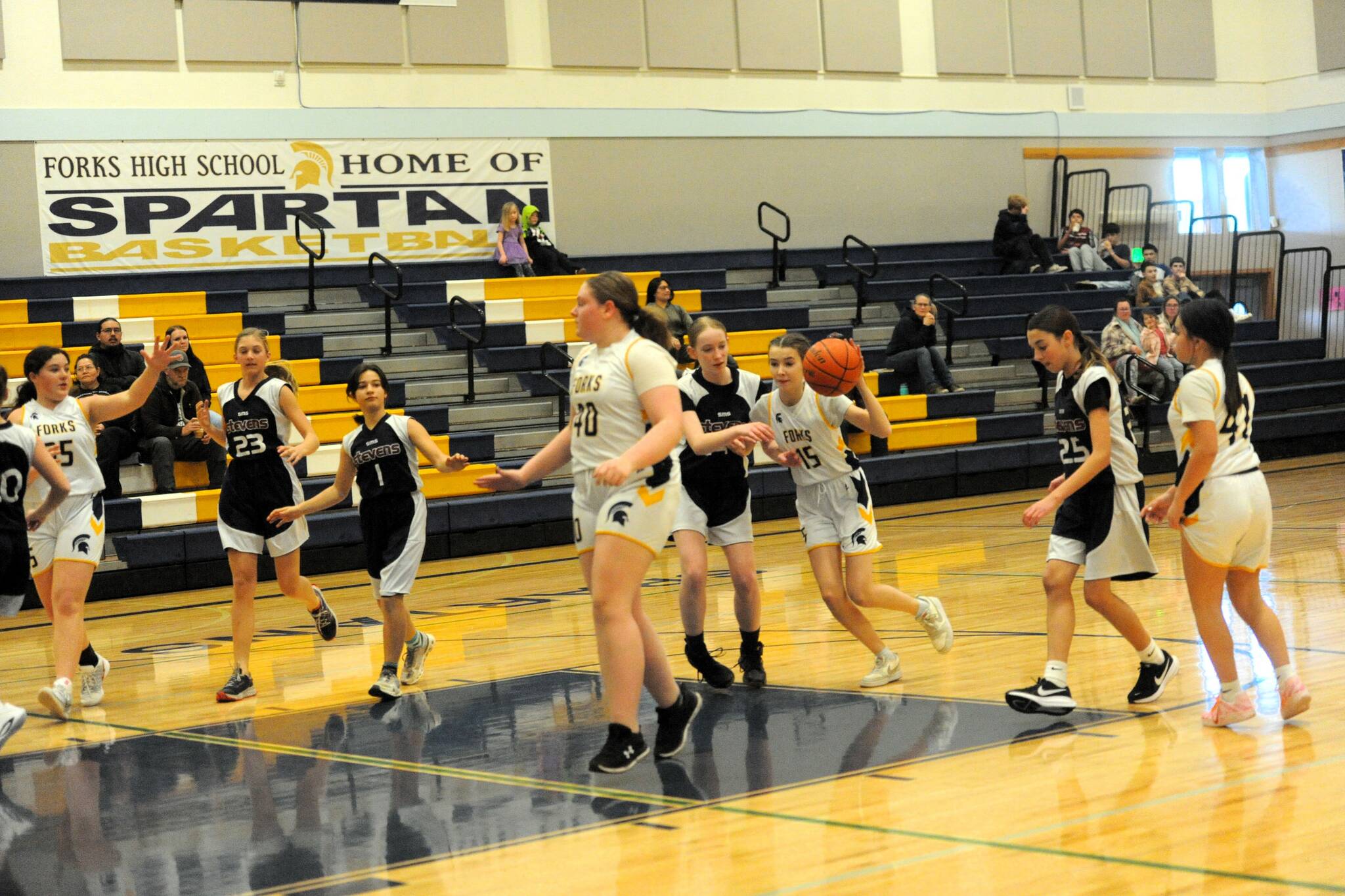 Photo by Lonnie Archibald 
Spartan Harper Beutler drove the lane against Stevenson during this 7th-grade JV contest in the Spartan Gym. Also in the action are Norah Enges (35), Ellie Hillcar (40), and Jessellen Ramos (41).