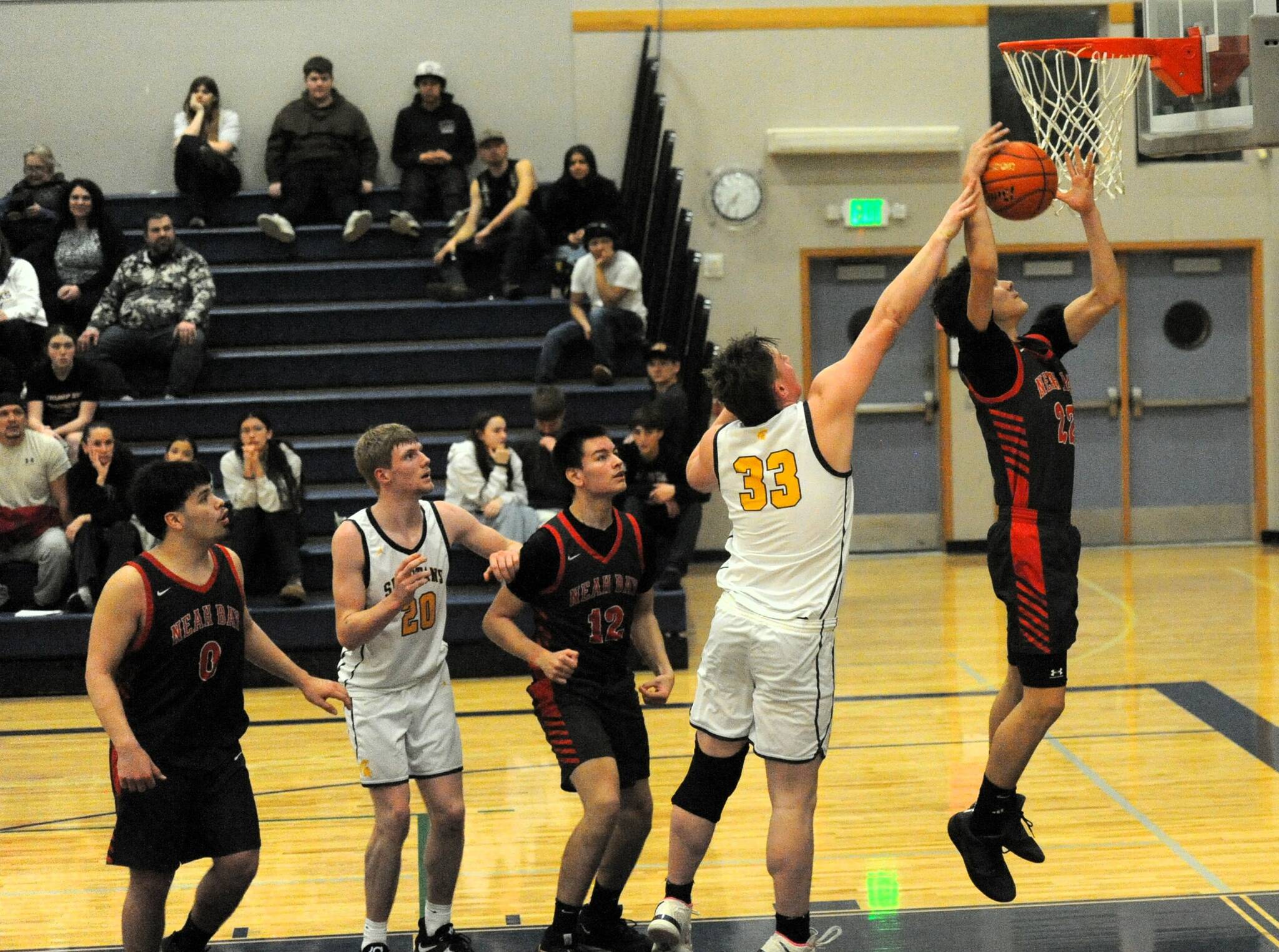 Red Devil Favor Ray (22) rebounds in front of Spartan Radly Bennett in the Forks Gym, where Neah Bay defeated Forks 66 to 55. Also pictured are Neah Bays Mathias Greene (0), Forks Ty Rowley (20) and Red Devil Echoes Chartraw (12). 
Photo by Lonnie Archibald
