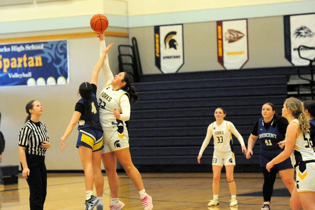 Photo by Lonnie Archibald
Forks 8th grader Chaz Fryberg tips it to the Spartans as Forks took on Crescent in the Forks Gym, where Crescent defeated Forks 19 to 9 in this non-league contest. Also in the action are Orryanna Gonzalez (33) and Sofia Huling (52).