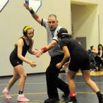 Forks Allie Lopez (left) sizes up her competition while the official signals the start of the match. No team scores were kept in this middle school meet.