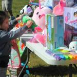 Spencer Harris, age three, checks out the prizes laid out for the 0 to 4-year-old participants.