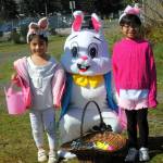 Vanesa and Ojana Montealegre with the Easter Bunny who met children near the gate to give out candy and hugs.
