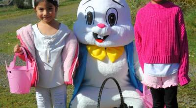 Vanesa and Ojana Montealegre with the Easter Bunny who met children near the gate to give out candy and hugs.
