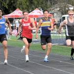 Spartan Noah Foster (second from the right) in a close race in the 100.