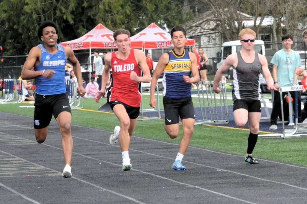 Spartan Noah Foster (second from the right) in a close race in the 100.