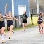 Forks Skye Hestand hands the baton to teammate Natasha Fletcher in the 4X2 relay.