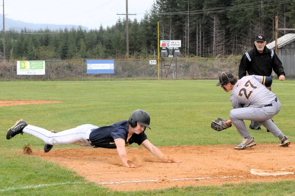 Spartan Landon Olson dives safely into third against the Ilwaco Fisherman who defeated Forks 6 to 0 and 11 to 2 in this double header in Beaver.