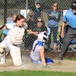 Forks catcher Fynlie Peters tags the Elma runner out at home assisted by a great throw from Spartan center fielder Bailey Johnson. Elma outlasted Forks winning 8 to 6 in a very well-played contest by both teams.