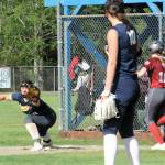 Forks first baseman Kailyn Crowder makes the play at first for the out against Hoquiam while pitcher Avery Dilley looks on. The shorthanded Spartans were defeated by Hoquiam 13 to 1 in this non-league contest.