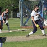 Forks pitcher Kendyl Woody releases the pitch against the Port Angeles JVs. Also in the action are Spartans Sophia Calderon, playing third base, and Avery Dilley covering first.