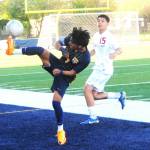Forks Darinel Garcia Lopez kicks back over his head for the save near the out-of-bounds line against Hoquiam.