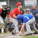 Angels pitcher Julian Sanchez takes the toss at home from catcher Rhett LeDuke for the out of Cubs runner Reed Weekes.