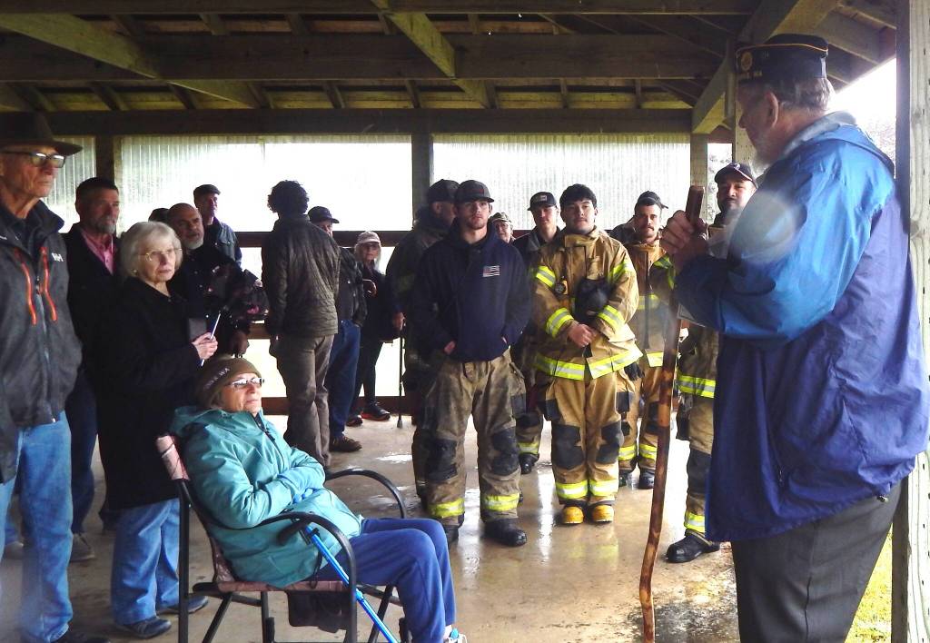 Photo Christi Baron 
Despite the rain, there was a good turnout for the Memorial Day ceremony. Forks American Legion member Joe Wright welcomes those attending and shared a few words about Memorial Day, the Unknown Soldier, and Taps.