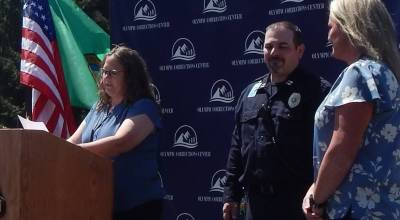 Photos Christi Baron
Olympic Corrections Center Superintendent Ginger Price reads the announcement honoring Jamie Kerschner, far right, as OCC Supervisor of the Year during the facilitys annual Corrections Appreciation Day celebration last Thursday. Looking on is OCC Captain Marc Thomas.