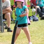 Mariner Leil Trainor, in pink with a pink helmet, pink bat, and pink shoes, came through with this base hit during T-Ball play.