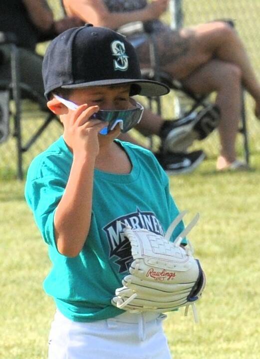 Mariner Andro Salizar wasnt sure whether or not to use the sunglasses. They probably worked well when going for a fly ball, but then maybe they seemed a little dark for keeping an eye on ground balls.