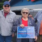 Donna Maxfield Hansen (holding the sign) was honored as the Parade Pioneer representing the Maxfield family. She was joined by her children, Donita Wakefield and Brad Parker (on the left), and were escorted through the parade by Judge Bruce Hanify on the right. Photo Christi Baron