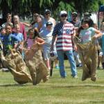 Below: They were jumping with joy during the Kiddies Playday gunny sack races Sunday at Tillicum Park.