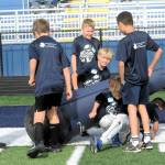 Several youngsters found entertainment in harassing the dummy just prior to the Neiko Thorpe football camp held Saturday, July 11, on the turf of Spartan Stadium.