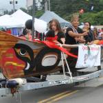 Quileute Days King Kaden Ward throws candy from a Quileute Canoe.