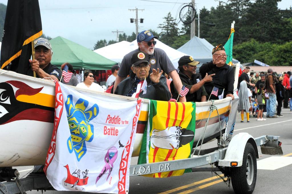 This Quileute Days canoe parade entry offered a Paddle for the Battle banner as Veterans waved to the crowd on Saturday.