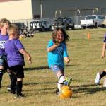 Sometimes it can create a problem if you have hair waving around in the breeze while trying to concentrate on making contact with the ball. That might have been the case here while the Sonics in blue took on the Purple Dragons in this 4-to 6-age group.