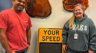 Submitted photo
New DOT-approved speed reminder signs will soon greet drivers entering Forks from both the north and south. One sign was purchased with approval from the Forks Chamber of Commerce Board, while the second was donated by Forks business owner and City Council member Vilkesh Patel. Pictured are Patel and Forks Chamber of Commerce Executive Director Lissy Andros with one of the new signs. It is hoped that when installed, the signs will encourage motorists to slow down as they enter the community.
