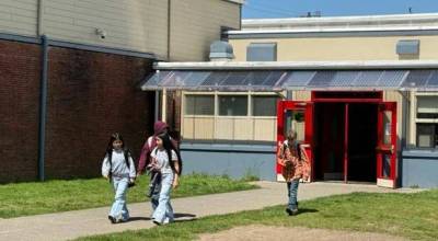 Submitted photo
Middle school students walk outdoors between four separate buildings during the school day. The proposed replacement school would improve safety and enhance learning by bringing all classrooms under one roof with a single secure entrance.